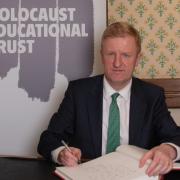 Oliver Dowden signing the Book of Commitment in Parliament
