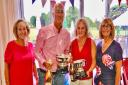 Ashleigh and Mike Davis receive their Mixed Jubilee Bowls trophies from club captain Lesley Hewitt (left) and ladies' captain Rosie Williams.