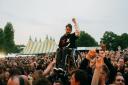 A fan in a wheelchair is lifted up by the crowd during Sum 41's set at Slan Dunk Festival South in Hatfield Park.