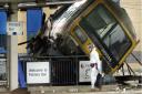 A crash investigator walks by the scene of the rail crash at Potters Bar station, Hertfordshire, in 2002.