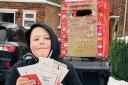Issac with the Christmas cards he received in his homemade post-box.