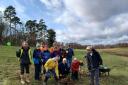 The final tree in Panshanger Park's new Queen's Wood being planted by volunteers.