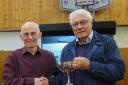 Potters Bar & District Photographic Society's President, Graham Coldrick (right) receives the trophy from independent judge, Malcolm Rapier.