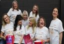 Potters Bar Theatre Company's Calendar Girls cast having a laugh with their collection buckets and bun T-shirts.