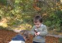 Children playing outdoors in autumn.