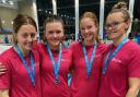 Hatfield Swimming Club members show off their medals from the East Region Championships.