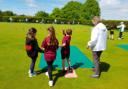 Bowlers at Welwyn & District show children from Welwyn St Mary's how to play bowls. Picture: WDBC