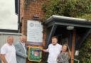 Ian Norman, Cllr Peter Hebden, Tom Sales and acupuncturist Helen Norman with the new defibrillator