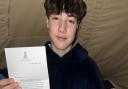 Ashley with his letter from Queen Camilla.