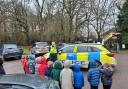 Young children try out police gear during school visit