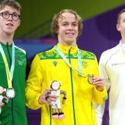 Daniel Wiffen (silver), Sam Short (gold) and Luke Turley (bronze) on the podium after the men's 1500m freestyle final