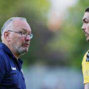 St Albans City manager Ian Allinson talks to Tom Bender during the friendly with Stevenage.