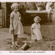 Princesses Elizabeth (later Queen Elizabeth II) and Margaret playing in the sandpit at St Paul's Walden Bury in Hertfordshire.