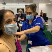 Patient Kamala receiving the COVID-19 booster vaccine at Roche in Welwyn Garden City