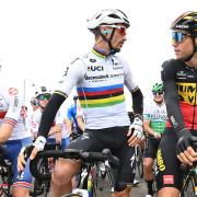 Oli Stockwell (left) next to world champion Julian Alaphilippe and eventual winner Wout van Aert at the start line on stage one of the Tour of Britain.