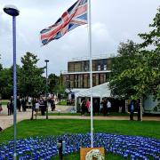 A wreath was laid next to 511 flags – one for every person who has died with COVID-19 at the East and North Herts NHS Trust