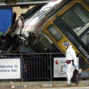 A crash investigator walks by the scene of the rail crash at Potters Bar station, Hertfordshire, in 2002.