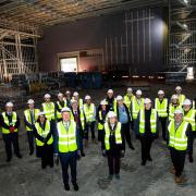 Representatives from Hertsmere Borough Council, Elstree Studios, RG Carter, Baqus and Herts LEP gather for the topping out ceremony of the new soundstages, the Platinum Stages. Pictured front row, middle, is Cllr Anne Swerling, with Cllr Morris Bright