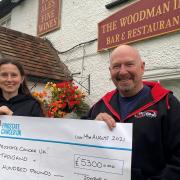 The Woodman’s Jana Suchanska and Paul Large, founder of 200BHP Road Trips, with the cheque for £5,300 for Prostate Cancer UK.