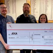 Justin Burgess of JOCA (middle) receives a cheque flanked by Alex Vooght and Rachel Elliott. Picture: WELWYN RUGBY