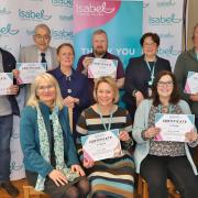 Isabel Hospice volunteers with their long-service certificates at Campus West in Welwyn Garden City.