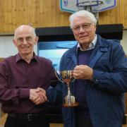 Potters Bar & District Photographic Society's President, Graham Coldrick (right) receives the trophy from independent judge, Malcolm Rapier.
