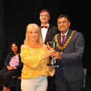 Rebekah Fortune of TACT receiving the Welwyn Cup from new Welwyn Hatfield Mayor, Councillor Pankit Shah.