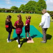 Bowlers at Welwyn & District show children from Welwyn St Mary's how to play bowls. Picture: WDBC