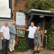 Ian Norman, Cllr Peter Hebden, Tom Sales and acupuncturist Helen Norman with the new defibrillator