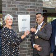 Minster House residents Lynn Francis receives her key from mayor Pankit Shah.