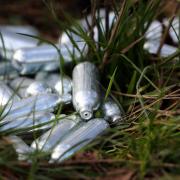 File photo of discarded canisters of nitrous oxide, or laughing gas. The Home Office said having nitrous oxide will be banned from November 8 and serious repeat offenders could be jailed for up to two years, with dealers facing up to 14 years in prison.