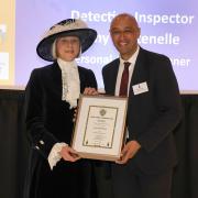 Detective Inspector Tony Fontenelle receiving the award from the High Sheriff for Hertfordshire Liz Green.